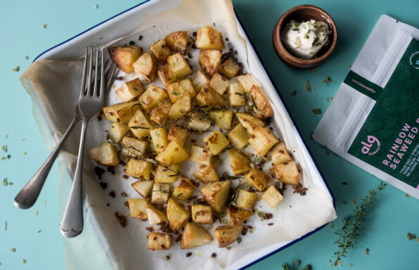 Roasted potato chunks with herbed garlic and seaweed, sour cream and packaging flatlay